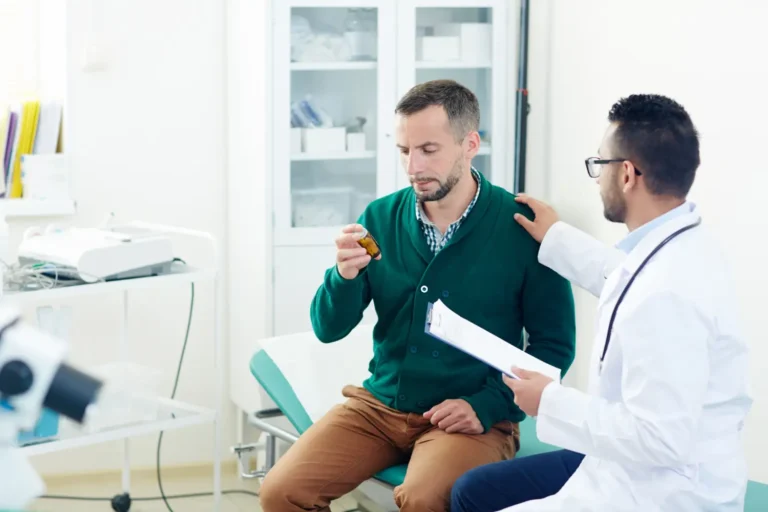 a man sitting on a couch holding a bottle of medicine-Men's Health Coaching & Fitness Training