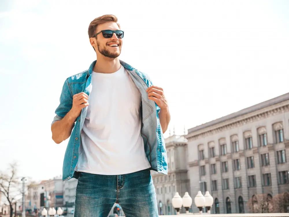 Confident smiling man in casual denim outfit symbolizing emotional intelligence, self-worth, and men's personal growth.